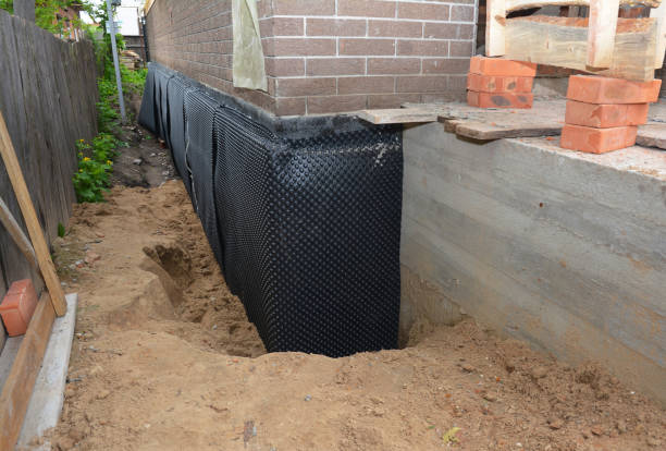 Happy homeowners after waterproofing job in Lake Grove
